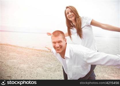 A beautiful happy caucasian couple in love on the beach