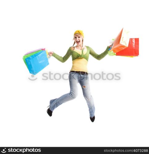 A beautiful happy caucasian girl jumping and carrying shopping bags