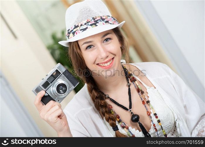 a beautiful hippie woman with a retro camera
