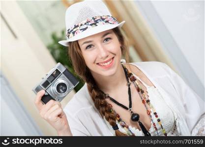 a beautiful hippie woman with a retro camera