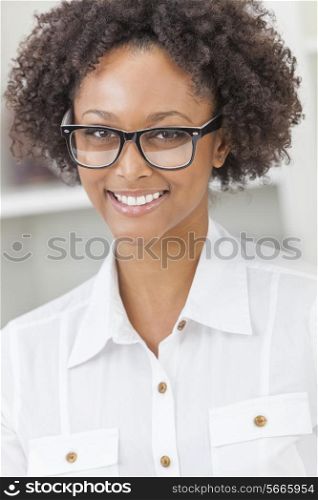 A beautiful intelligent mixed race African American girl or young woman looking happy and wearing geek glasses