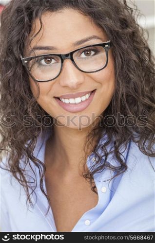 A beautiful intelligent mixed race Latina girl or young woman looking happy and wearing geek glasses