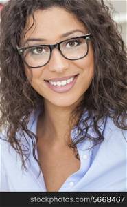 A beautiful intelligent mixed race Latina girl or young woman looking happy and wearing geek glasses
