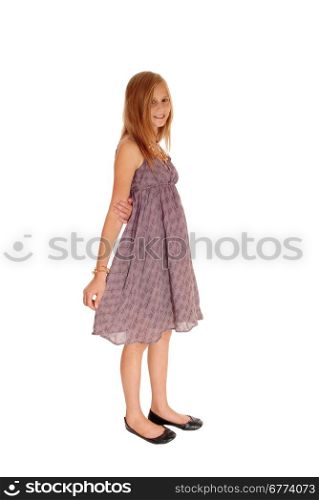 A beautiful little girl standing in a burgundy dress isolated for whitebackground.