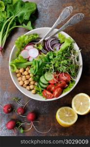 A beautiful Mediterranean salad of delicate leaves of lettuce and spinach, with the addition of Nuta, slices of fresh radish, tomato, cucumber and microsegment of radish. This is the perfect dish for those who are watching their health.. Vegetable salad of chickpeas and sprouts