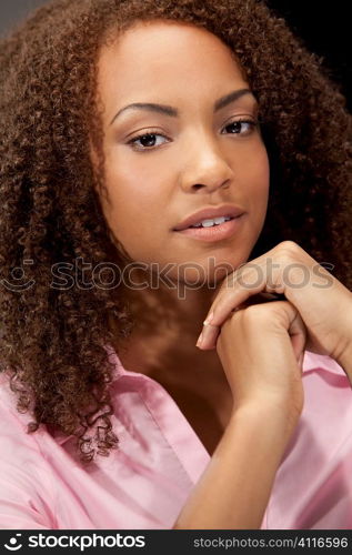 A beautiful miced race African American girl laying down with perfect teeth and smile