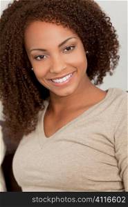 A beautiful mixed race African American girl laying down with perfect teeth and smile