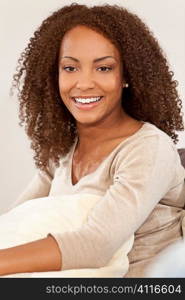A beautiful mixed race African American girl laying down with perfect teeth and smile
