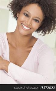 A beautiful mixed race African American girl or young woman looking happy and smiling with perfect teeth