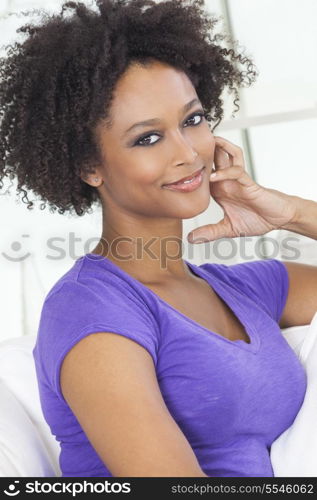 A beautiful mixed race African American girl or young woman looking happy and thoughtful