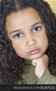 A beautiful mixed race African American little girl female child looking sad and sulking