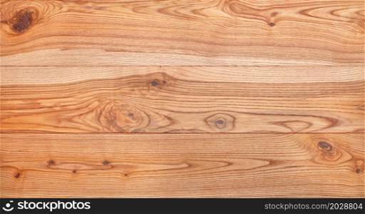 A beautiful pattern of ash planks in the form of a smooth wooden surface with horizontal lines of fibers, panoramic image for a banner.. Beautiful texture of a natural ash board with a horizontal grain pattern.