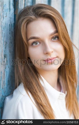 A beautiful portrait of a young girl in the sunlight.. A beautiful young girl is leaning against the wall in the sunlight 3687.