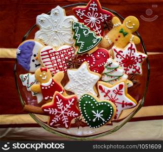 A beautiful selection of traditionally decorated gingerbread cookies for Christmas served on a blass bowl