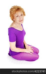 A beautiful seventy year old woman kneeling in her workout clothes. White background.