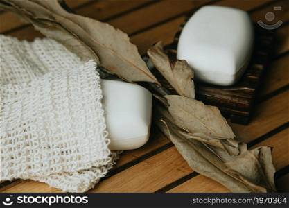 A beautiful shot of a hard soap over a soap dish with autumnal motives and leaves