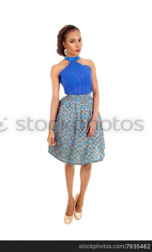A beautiful slim African American woman standing in a lovely skirtand blue blouse isolated for white background.