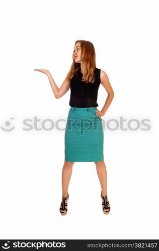 A beautiful slim blond woman standing isolated for white backgroundlooking up and one hand up.