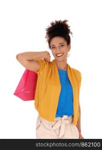 A beautiful smiling multi-racial woman standing with her shopping bag over her shoulder in a yellow sweater in close up, isolated for whitebackground