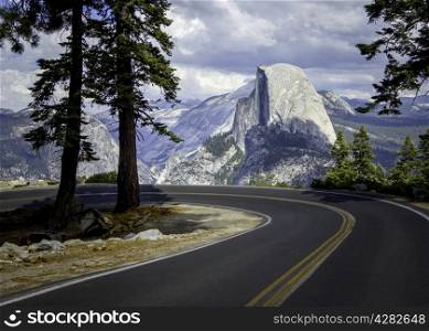 A beautiful stunning landscape picture of a winding road in the Yosemite mountains with El Capitan mountain in the background