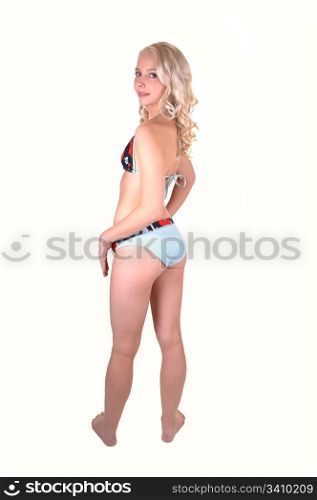 A beautiful teenager with long blond hair and a blue bikini, standing from theback and looking over her shoulder for white background.