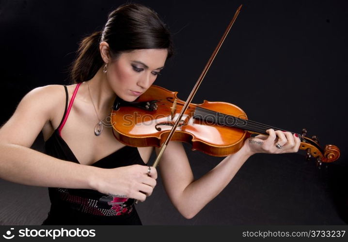 A Beautiful Violinist looks at her instrument