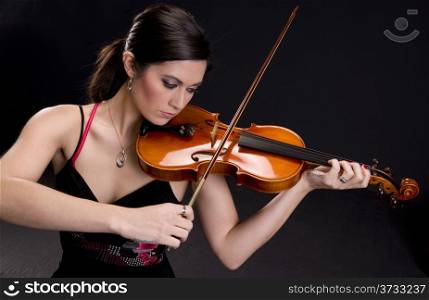 A Beautiful Violinist looks at her instrument