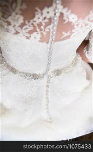 a beautiful white wedding dress close-up shot. a beautiful white wedding dress closeup shot