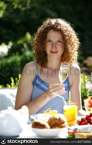 A beautiful woman drinking champagne