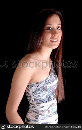 A beautiful woman in a nice dress standing from the side in the studio for black background.