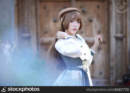 A beautiful woman in lolita dress in garden background Japanese street fashion portrait