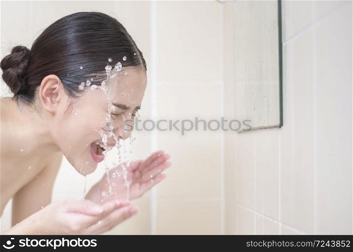 A beautiful woman is washing her face