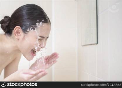 A beautiful woman is washing her face