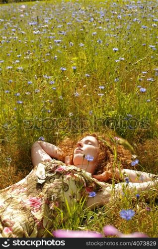 A beautiful woman lying in a field of flowers