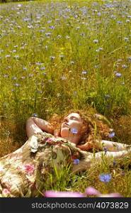 A beautiful woman lying in a field of flowers