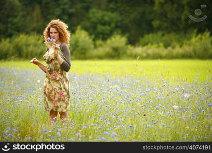 A beautiful woman picking flowers