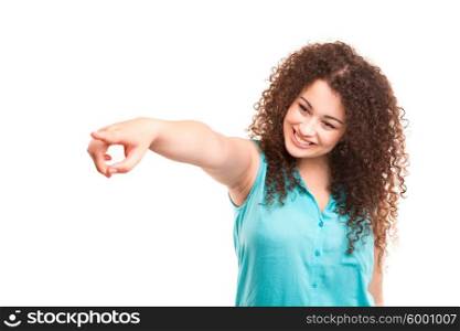 A beautiful woman pointing to something, isolated over a white background