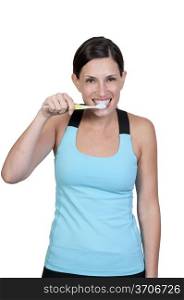 A beautiful woman practicing good oral dental care by brushing her teeth