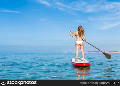 A beautiful woman practicing paddle on a beautiful sunny day