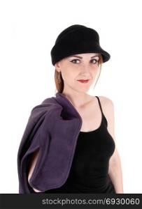 A beautiful woman with a hat and her winter coat over her shoulderstanding in close up, isolated for white background