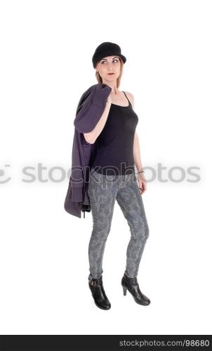 A beautiful woman with a hat and her winter coat over her shoulderstanding in heels isolated for white background