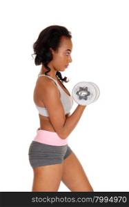 A beautiful young African American woman in a gray sports bra and shorts exercising with dumbbell&rsquo;s, isolated for white background.