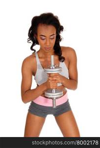 A beautiful young African American woman in a gray sports bra and shorts, exercising with dumbbell&rsquo;s, isolated for white background.