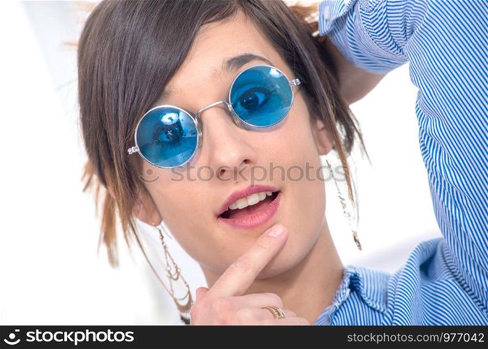 a beautiful young brunette woman with blue glasses