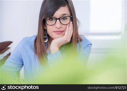 a beautiful young brunette woman with glasses