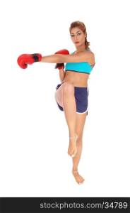 A beautiful young Caucasian woman in a pose of kickboxing, standingon one leg, isolated for white background.