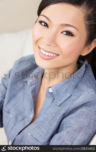 A beautiful young Chinese Asian Oriental woman with a wonderful toothy smile