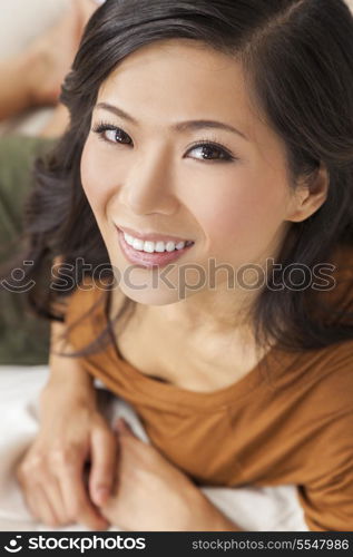 A beautiful young Chinese Asian Oriental woman with a wonderful toothy smile