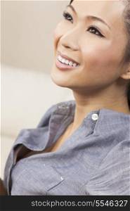 A beautiful young Chinese Asian woman with a wonderful toothy smile