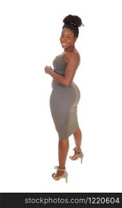 A beautiful young curvy African American female standing in a tight gray dress, showing her figure, isolated for white background